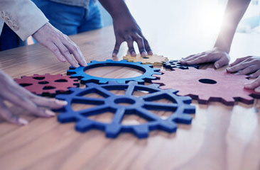 A freelance web designer is like this Image of putting together the pieces of a gear, like the moving parts of a website